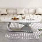 Table basse avec plateau en céramique et base contemporaine en acier inoxydable, une pièce maîtresse durable et élégante pour le salon.